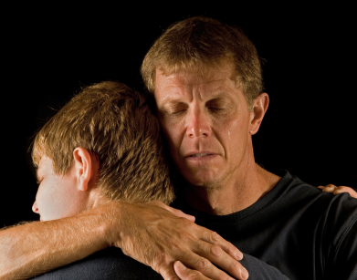 Father and son in emotional embrace